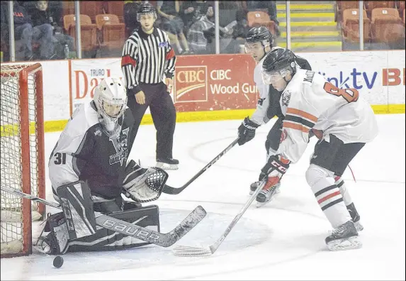 ?? TrUro DAILY NEWs pHoto ?? Cameron MacLeod of the Bearcats swoops in on a loose puck as Valley netminder Jacob Stewart looks to close the door on the Truro attacker. A shootout was needed Saturday to decide the game, with the Bearcats taking a 4-3 decision.