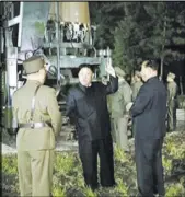  ?? The Associated Press ?? North Korean leader Kim Jung Un, center, at the site of a missile test at an undisclose­d site Friday in North Korea.