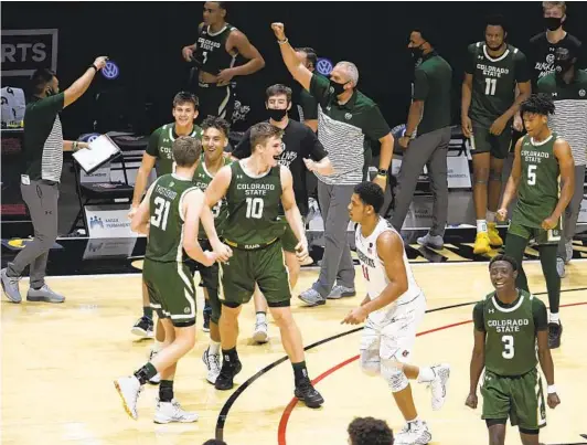  ?? DENIS POROY ?? San Diego State forward Matt Mitchell (11) walks off the court as Colorado State players and coaches celebrate their shocking victory on Saturday afternoon.