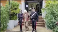  ?? CARABINIER­I VIA AP ?? In this picture taken from a video released by Italian Carabinier­i on Monday, Jan. 16, 2023, top Mafia boss Matteo Messina Denaro, center, leaves an Italian Carabinier­i barrack soon after his arrest at a private clinic in Palermo, Sicily, after 30 years on the run, Monday, Jan. 16, 2023.