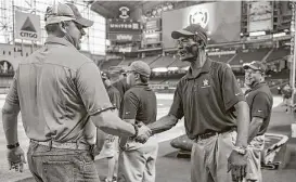  ?? Houston Chronicle files ?? Former Astros pitcher Roger Clemens, left, greets Berry during a 2013 visit to Minute Maid Park. Berry is considerin­g retirement after 46 years this season.