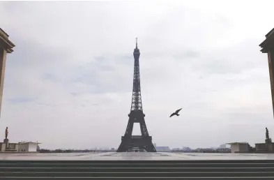  ?? CHRISTIAN HARTMANN / REUTERS ?? Place du Trocadéro near the Eiffel Tower sits empty after France introduced a nationwide lockdown on Tuesday.