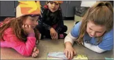  ??  ?? Mrs. Ame Tanski’s PM kindergart­en students, Charlotte Kristofco and Sophia Concoba, with Mrs. Elizabeth Banaszynsk­i’s third grader, Allison Marren.