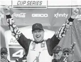  ?? CHRIS GRAYTHEN/GETTY ?? Kurt Busch, driver of the #45 Jordan Brand Toyota, celebrates after winning the NASCAR Cup Series race at Kansas Speedway on Sunday.