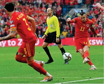  ?? AFP/REUTERS ?? Decisive moment: Bale hits his match-winning free-kick while (right) Ukraine keeper Bushchan cannot believe it after Yarmolenko heads past him