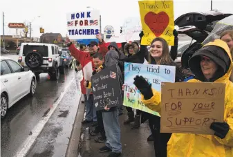  ?? Ty Wright / New York Times ?? Educators and students hold signs in support of a statewide teacher strike in Morgantown, W.Va., last Tuesday. Teachers in the state got a 5 percent raise after a nine-day walkout.