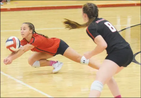  ?? RICK PECK/ SPECIAL TO MCDONALD COUNTY PRESS ?? McDonald County libero Kaycee Factor dives to save a ball as teammate Katelyn Ferdig looks on during the Lady Mustangs’ 25-14, 25-18, 25-18 win over Cassville on Oct. 21 at MCHS.