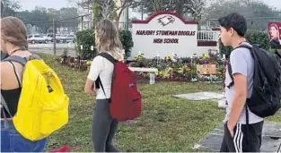  ??  ?? A new marker and garden were unveiled Sunday at Marjory Stoneman Douglas High School in Parkland. The garden, called “Project Grow Love” pays tribute to the 17 people killed at the school on Feb. 14, 2018.