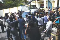  ??  ?? MEMBERS OF THE MEDIA surround a North Korea official’s car as it leaves the North Korea embassy in Kuala Lumpur, Malaysia, Feb. 22.