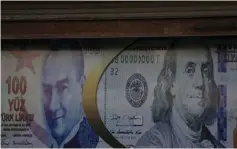  ?? (Khalil Ashawi/Reuters) ?? A POSTER of Turkish and American currency adorns a money exchange shop. The sharp hike in Turkey’s inflation rate ‘is not something that can be ignored.’