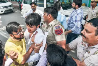  ?? ?? POLICE DETAIN Akhil Bharatiya Vidyarthi Parishad members protesting against alleged irregulari­ties in CUET UG and NET exams, outside the National Testing Agency office in New Delhi on August 8.