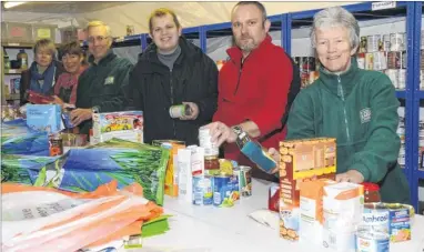  ??  ?? Food Bank volunteers busy making up parcels for clients