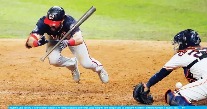  ??  ?? HOUSTON: Adam Eaton #2 of the Washington Nationals is hit by the pitch against the Houston Astros during the ninth inning in Game Six of the 2019 World Series at Minute Maid Park in Houston, Texas. — AFP