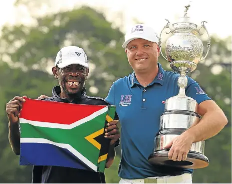  ?? /Luke Walker/Sunshine Tour/Gallo Images ?? Winning team: Graeme Storm, from Britain, with the South African Open trophy and his caddie Thama Jeffrey Nkonyane were on top of the world after a nail-biting play-off with world No 2 Rory McIlroy at Glendower on Sunday.