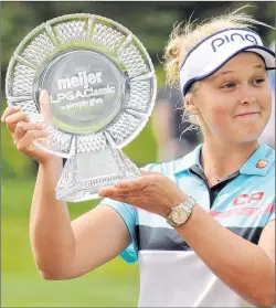  ?? CP PHOTO ?? Brooke Henderson poses with the trophy after winning the Meijer LPGA Classic golf tournament at Blythefiel­d Country Club earlier this year in Grand Rapids, Mich..