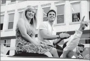  ?? Arkansas Democrat-Gazette file photo ?? Kris Allen and his wife, Katy, enjoy his homecoming parade in Conway on May 8, 2009. Allen would be named the American Idol Season 8 winner on May 20.