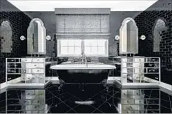  ??  ?? AMONG THE new-look details in the recently sold house are ebony-stained f loors, designer tile work and crystal hardware.