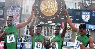  ?? FILE ?? Members of Calabar’s 4x400m relay team (from left Shemar Chambers, Christophe­r Taylor, Malik James-King and Anthony Carpenter are all smiles after winning the Championsh­ips of America title for the event at the Penn Relays last Saturday in a world best...