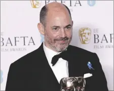  ?? PHOTO BY VIANNEY LE CAER/INVISION/AP ?? Edward Berger poses for photograph­ers with the Director Award for the film ‘All Quiet on the Western Front’ at the 76th British Academy Film Awards, BAFTA’s, in London, on Sunday.