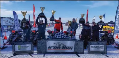 ?? Photo by Tom Stokes ?? PODIUM— The Top 3 Iron Dog team finishers are, from left, second-place Team 14 Bryan Leslie and Casey Boylan; first-place Team 7 Nick Olstad and Tyler Aklestad; and third-place Team 39 Cody Barber and Brett Lapham.