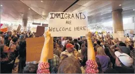  ?? Genaro Molina Los Angeles Times ?? HUNDREDS of people protest President Trump’s attempt to ban travelers from six Muslim-majority countries at Los Angeles Internatio­nal Airport on Jan. 29.