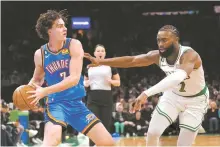  ?? AP-Yonhap ?? Oklahoma City Thunder forward Chet Holmgren, left, looks to pass while pressured by Boston Celtics guard Jaylen Brown, right, during the first half of an NBA basketball game in Boston, Monday.
