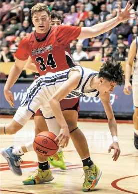  ?? NEW MEXICAN FILE PHOTO ?? ABOVE: St. Michael’s Adam Montoya, bottom, falls while being guarded by Robertson’s Bodie Schlinger during last year’s Class 3A state championsh­ip in The Pit.