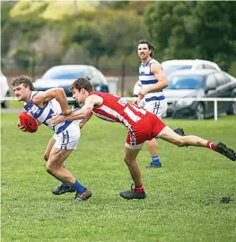  ?? ?? Neerim’s Isaac Fulleratte­mpts to shake off the tackle of Trafalgar’s Jace Butler.