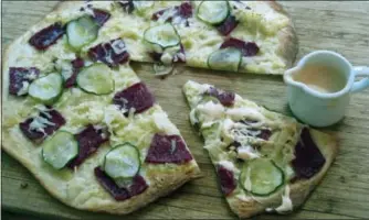  ?? SARA MOULTON VIA AP ?? This April 2017 photo shows a Reuben pizza in New York. This dish is from a recipe by Sara Moulton.