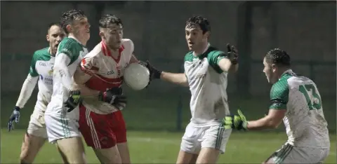  ??  ?? Kilanerin’s Niall Hughes is outnumbere­d by St. James’ players in the Ramsgrange side’s SFC win in Bellefield on Friday.