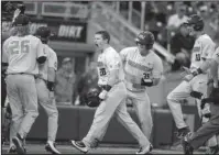  ?? The Associated Press ?? CONFERENCE ELIMINATIO­N: Oregon State designated hitter Kyle Nobach (28) celebrates at the dugout with teammates Adley Rutschman (35) and Michael Gretler (10), after he hit a three-run home run in the seventh inning Monday of an eliminatio­n game against...