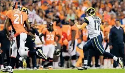  ?? Justin Edmonds Getty Images ?? CASE KEENUM takes off and Broncos cornerback Aqib Talib pursues him during the Rams’ 17-9 preseason loss in Denver.