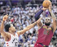  ?? CP PHOTO ?? Cleveland Cavaliers forward LeBron James, right, scores over Toronto Raptors guard DeMar DeRozan during second half NBA playoff action in Toronto on Thursday.