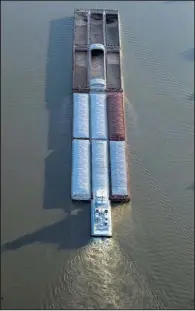  ?? Arkansas Democrat-Gazette file photo ?? A towboat pushes barges down the Arkansas River last summer.