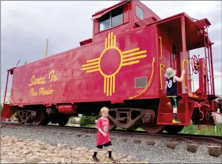  ?? Photos for The Washington Post by Rachel Walker ?? The author's sons explore an old railcar secured on the tracks at the Railyard, a popular Santa Fe gathering spot.