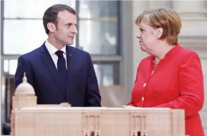  ?? Agence France-presse ?? Angela Merkel and Emmanuel Macron stand behind a model of the Humboldt Forum in Berlin.