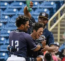  ?? MICHAEL P. PAYNE — FOR THE NEWS-HERALD ?? The Captains’ Tyler Freeman is congratula­ted by teammates after his game-winning hit May 19, 2019at Classic Park.