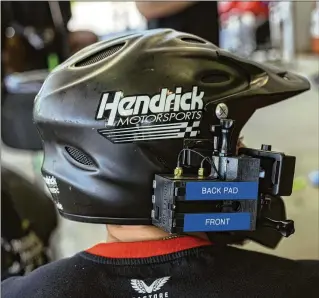  ?? ?? Teams agree that NASCAR has increased the sport’s visibility and access, evidence of which is this pit crew member wearing a helmet-mounted camera during a training session at the Hendrick Motorsport­s headquarte­rs near Charlotte. TV viewership and racetrack attendance have risen in recent years for NASCAR, but many of the racing teams said they still lose money.