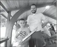  ?? NWA Democrat-Gazette/FLIP PUTTHOFF ?? James Howell, 9, shows Friday his finished aluminum sword while standing with his dad, Daniel Howell.