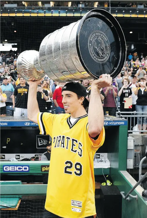  ?? JUSTIN BERL / GETTY IMAGES ?? Penguins goalie Marc-Andre Fleury, celebratin­g with the Stanley Cup at a Pittsburgh Pirates game at PNC Park on Tuesday, is one of the players who will likely be on the move soon to another club.