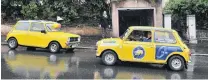  ?? PHOTO: ODT FILES ?? On a mission . . . Minis taking part in a previous Pork Pie Charity Run stop outside the garage in Royal Tce, Dunedin, that featured in the original Goodbye Pork Pie movie