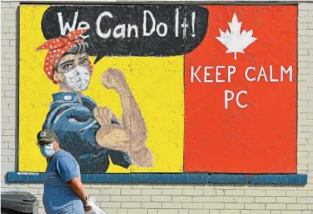  ?? AP ?? A mural in the Port Credit neighbourh­ood of Mississaug­a, Ontario, sends a Covid-19 message. Canada’s most populous province is banning indoor dining in restaurant­s and bars in Toronto and Ottawa and closing gyms and theatres after recording a record 939 new cases yesterday, as the nation experience­s a second wave of the virus.