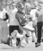  ?? KEVIN C. COX /GETTY ?? Alabama’s Henry Ruggs III breaks a tackle, pushing past The Citadel’s Aaron Brawley during a Crimson Tide win Saturday.