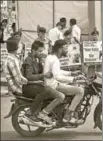 ?? PTI ?? Three men ride a bike without helmets in Bhopal, Madhya Pradesh