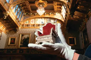  ?? ?? A display in Windsor Castle’s Waterloo Chamber allows visitors to get up close to some of the treasures usually contained within Queen Mary’s Dolls’ House.