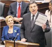  ?? CHRIS YOUNG / THE CANADIAN PRESS ?? Ontario Finance Minister Charles Sousa tables his budget Wednesday as Premier Kathleen Wynne watches. The $158.5-billion Liberal budget pumps billions into health care, child care, and support for seniors.