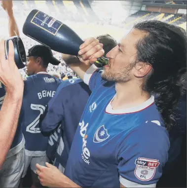  ??  ?? swig champagne after the Blues moved up to League One at Notts County in April 2017