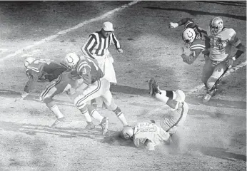  ?? ASSOCIATED PRESS ?? Baltimore Colts quarterbac­k Johnny Unitas follows the blocking of Bob Vogel (72) as he runs for a first down to the Oakland Raiders 10-yard line during the 1971 AFC championsh­ip game at Memorial Stadium in Baltimore.