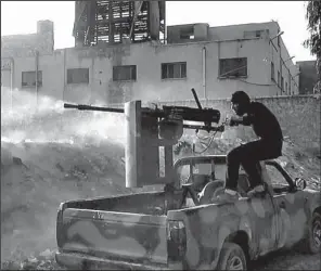  ?? AP ?? A Syrian rebel in Aleppo on Saturday shoots toward government troops loyal to President Bashar
Assad.