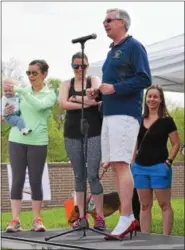  ?? MARIAN DENNIS – DIGITAL FIRST MEDIA ?? Montgomery County District Attorney Kevin Steele speaks to the crowd about domestic violence as he prepares to take the mile-long walk in red heels. The Walk a Mile in Her Shoes event is aimed at rallying men to take an active role in supporting...